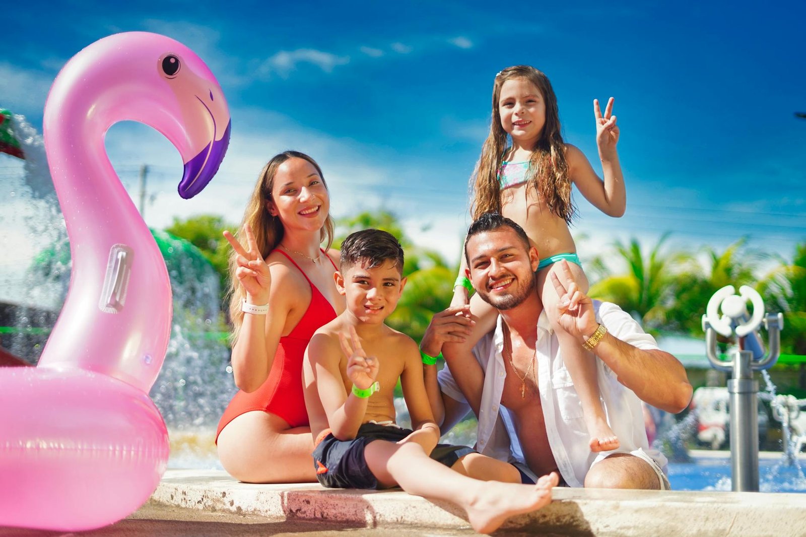 happy family sitting on poolside